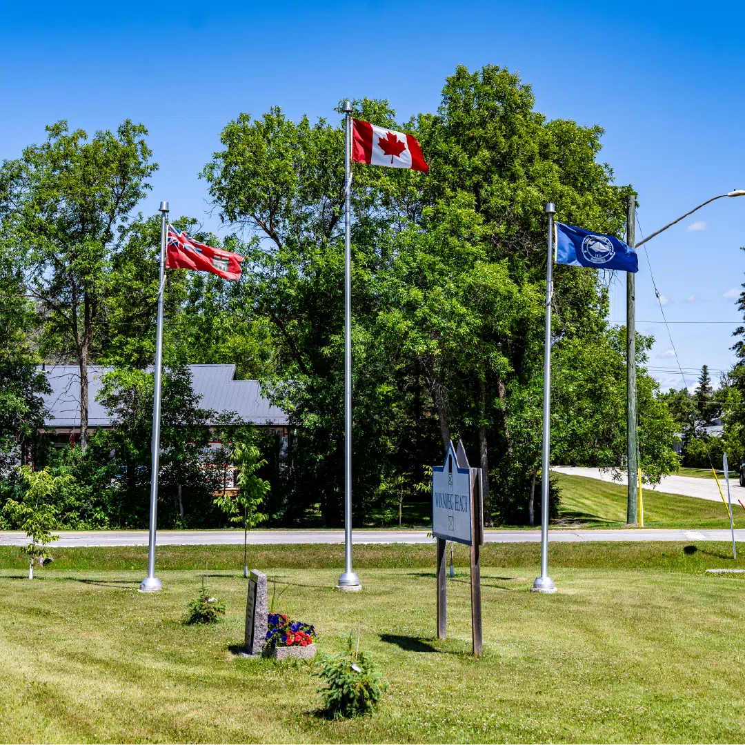 Three Ewing Flagpoles displaying a Canada flag, Manitoba flag, and Custom Winnipeg Beach Municipal flag