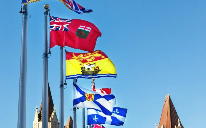 Provincial Flags | The Flag Shop BC, Manitoba, New Brunswick, Nova Scotia, Quebec, Ontario and Canada flags flying on commercial poles.